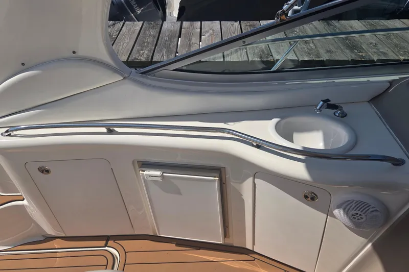 Slide: The Image of 2003 Sea Ray 300 Sundancer boat interior with sink and storage compartments. - 17