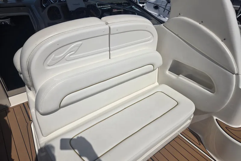 Slide: The Image of White leather seating on 2003 Sea Ray 300 Sundancer boat, featuring elegant design and comfort. - 19