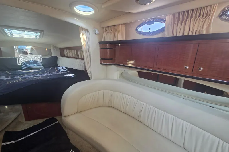 Slide: The Image of Interior of 2003 Sea Ray 300 Sundancer with cozy seating and elegant wood cabinetry. - 25