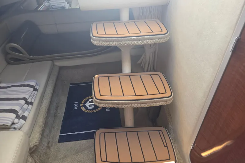 Slide: The Image of Interior steps of a 2003 Sea Ray 300 Sundancer yacht, featuring cushioned treads. - 30