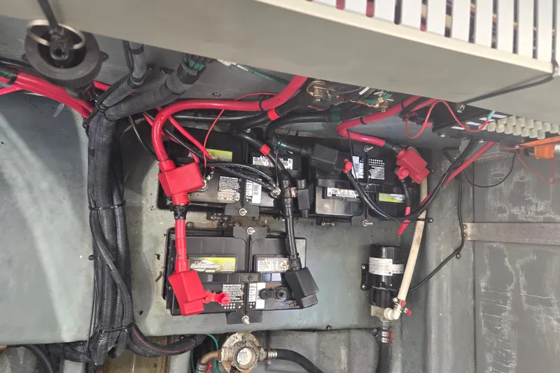 Slide: The Image of Engine compartment of 2003 Sea Ray 300 Sundancer showing batteries and wiring. - 32