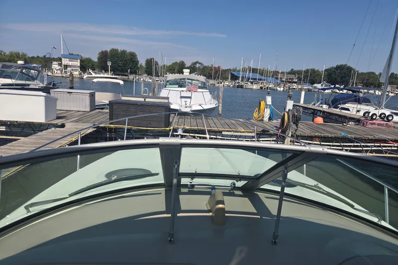 Slide: The Image of 2003 Sea Ray 300 Sundancer docked at a marina with other boats. - 36