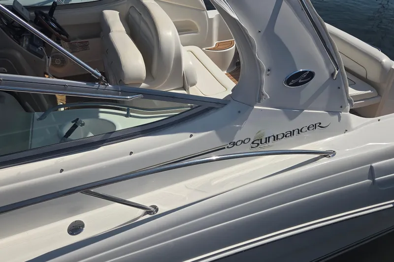 Slide: The Image of 2003 Sea Ray 300 Sundancer boat with sleek design and comfortable seating. - 4