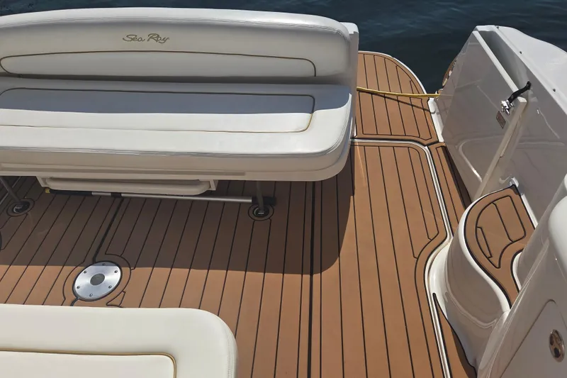 Slide: The Image of 2003 Sea Ray 300 Sundancer boat deck with cushioned seating and teak flooring. - 8