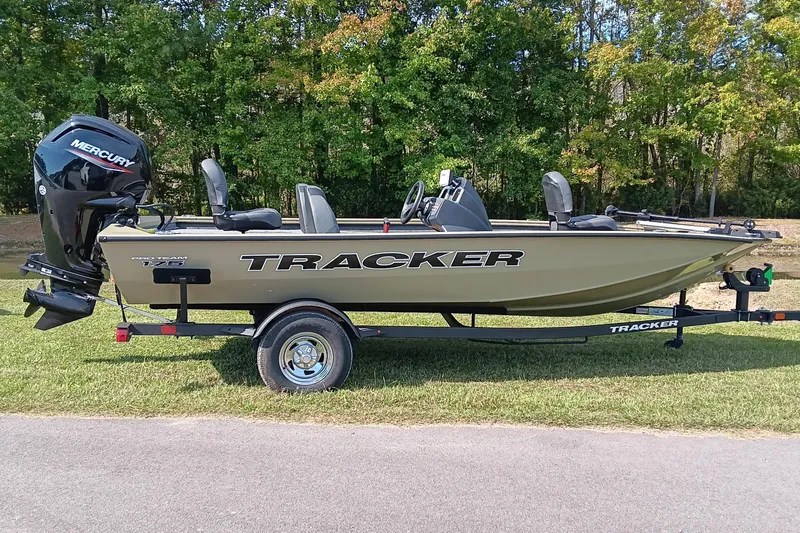 The Image of 2026 Tracker Pro Team 175 boat with Mercury engine on trailer, parked on grass. - 1