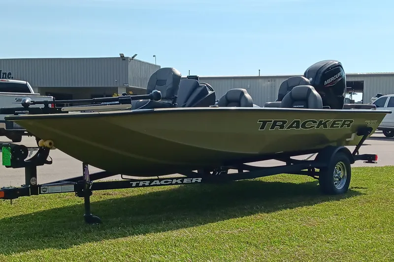Slide: The Image of 2026 Tracker Pro Team 175 boat on trailer, parked on grass, with Mercury engine. - 6