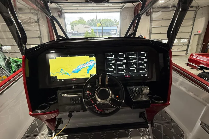 Slide: The Image of 2025 Nor-Tech 390 Sport dashboard with navigation and control screens in a modern boat interior. - 26