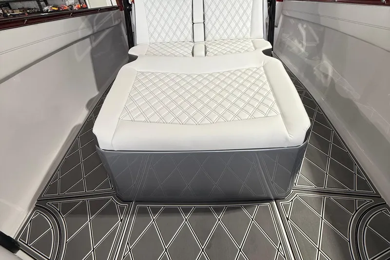 Slide: The Image of Luxurious interior of 2025 Nor-Tech 390 Sport boat with quilted seating and patterned flooring. - 28