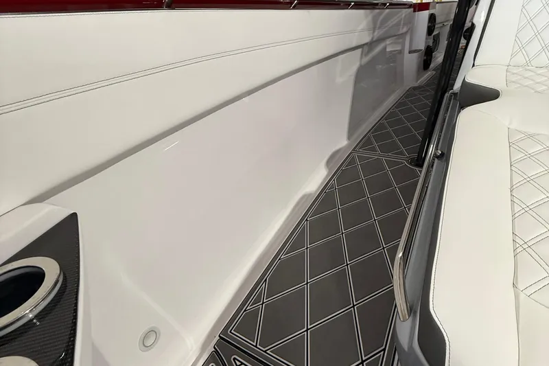 Slide: The Image of 2025 Nor-Tech 390 Sport interior with sleek white seating and diamond-patterned flooring. - 29