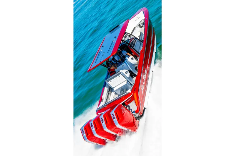 Slide: The Image of 2025 Nor-Tech 390 Sport boat with four powerful engines cruising on blue water. - 3