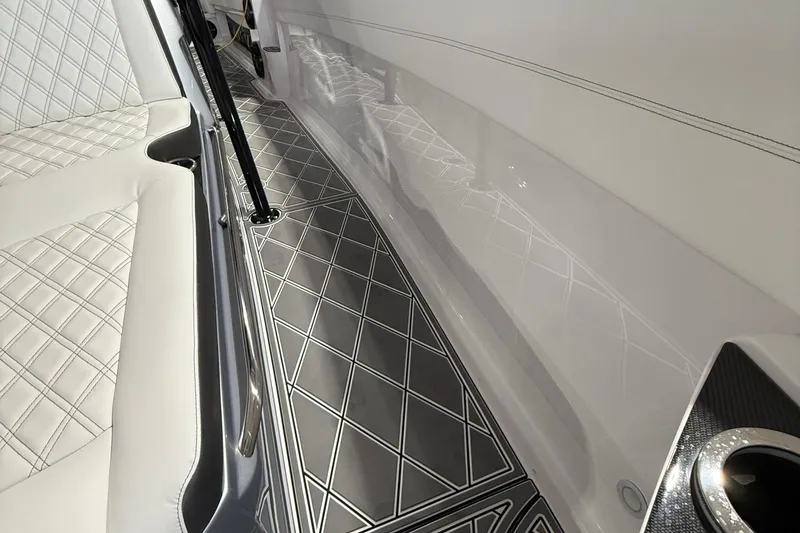 Slide: The Image of Interior of 2025 Nor-Tech 390 Sport boat with quilted seating and sleek flooring design. - 30