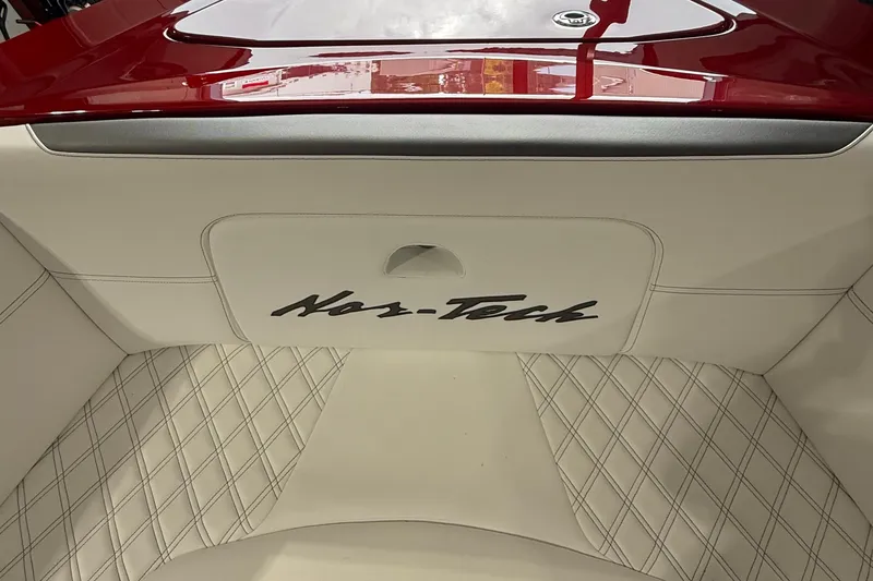 Slide: The Image of 2025 Nor-Tech 390 Sport boat interior with white diamond-stitched upholstery and red accents. - 32