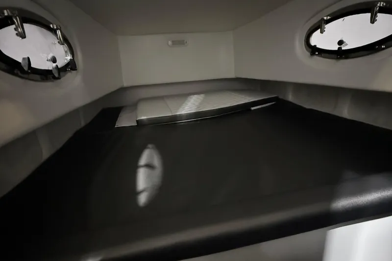 Slide: The Image of Interior cabin of 2025 Nor-Tech 390 Sport boat, featuring sleek design and porthole windows. - 39