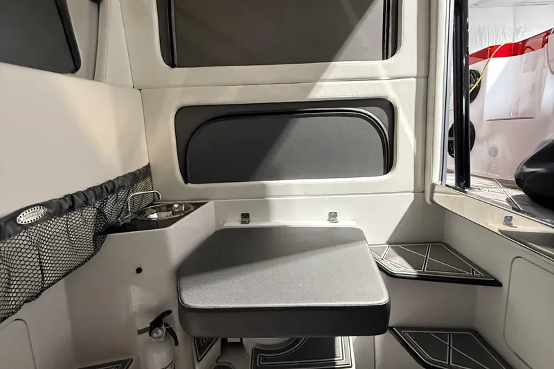 Slide: The Image of Interior of 2025 Nor-Tech 390 Sport boat, featuring seating and compact sink area. - 41
