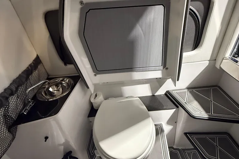 Slide: The Image of 2025 Nor-Tech 390 Sport boat interior with compact bathroom and modern fixtures. - 43