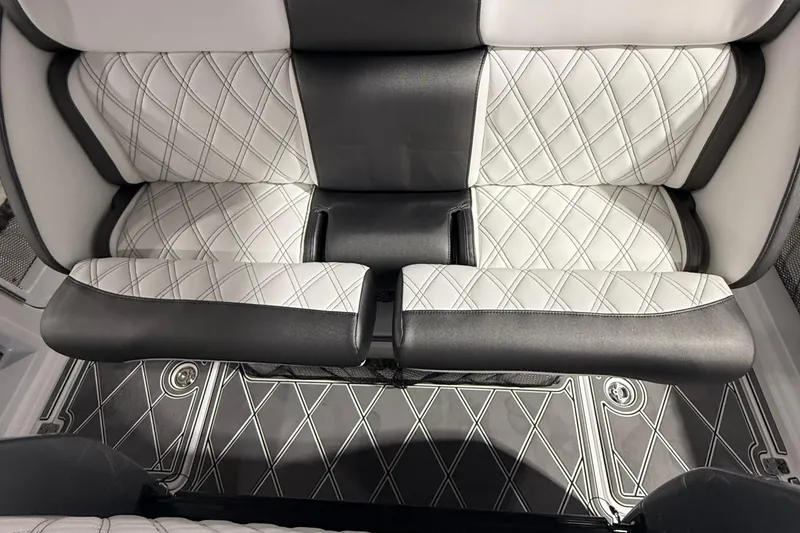 Slide: The Image of Luxurious seating in the 2025 Nor-Tech 390 Sport boat with diamond-stitched upholstery. - 45