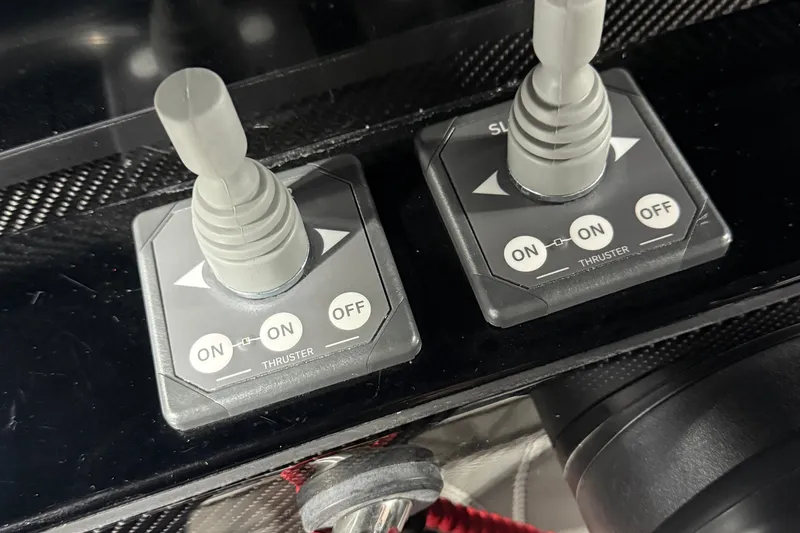 Slide: The Image of Control panel of 2025 Nor-Tech 390 Sport boat with thruster switches. - 46