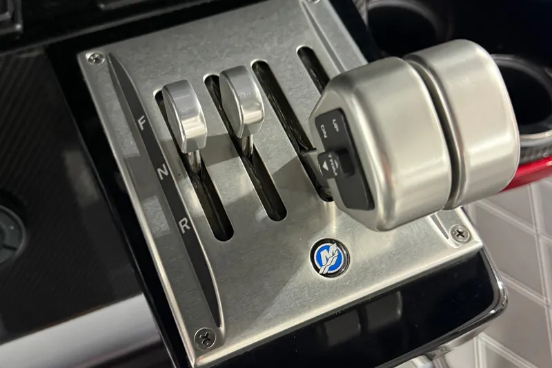Slide: The Image of Throttle controls of a 2025 Nor-Tech 390 Sport boat, featuring sleek metallic levers. - 47