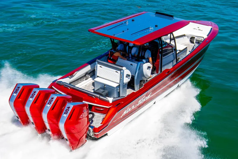 Slide: The Image of 2025 Nor-Tech 390 Sport boat with four powerful engines cruising on open water. - 5