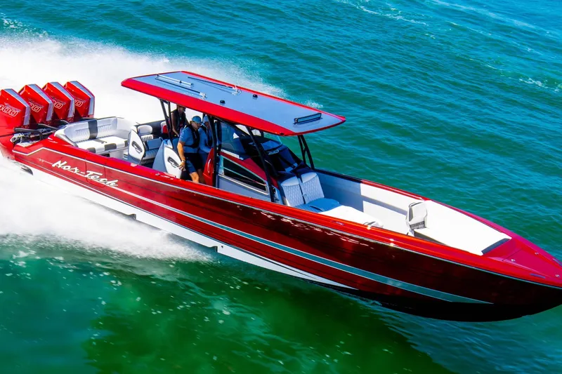 Slide: The Image of 2025 Nor-Tech 390 Sport boat cruising on clear blue water. - 7