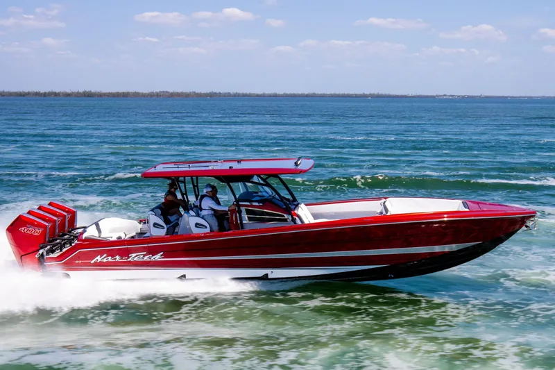 Slide: The Image of 2025 Nor-Tech 390 Sport boat cruising on open water, vibrant red design. - 8
