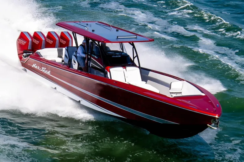 Slide: The Image of 2025 Nor-Tech 390 Sport boat speeding on ocean waves, vibrant red design. - 9