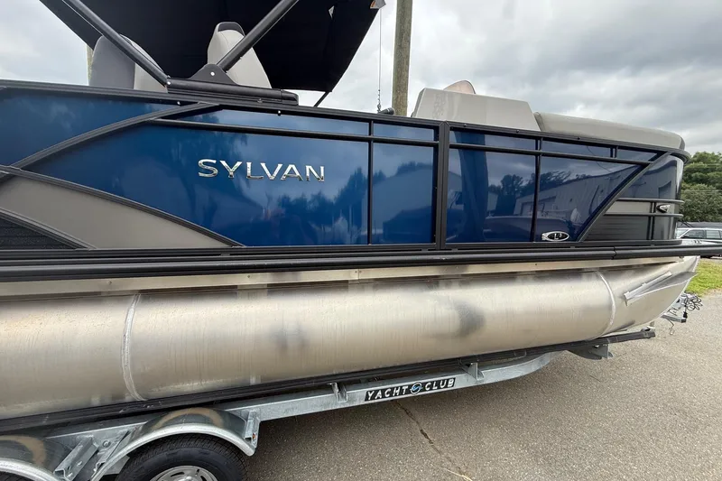 Slide: The Image of 2026 Sylvan L-3 RLZ DH pontoon boat on trailer, blue and silver design. - 4