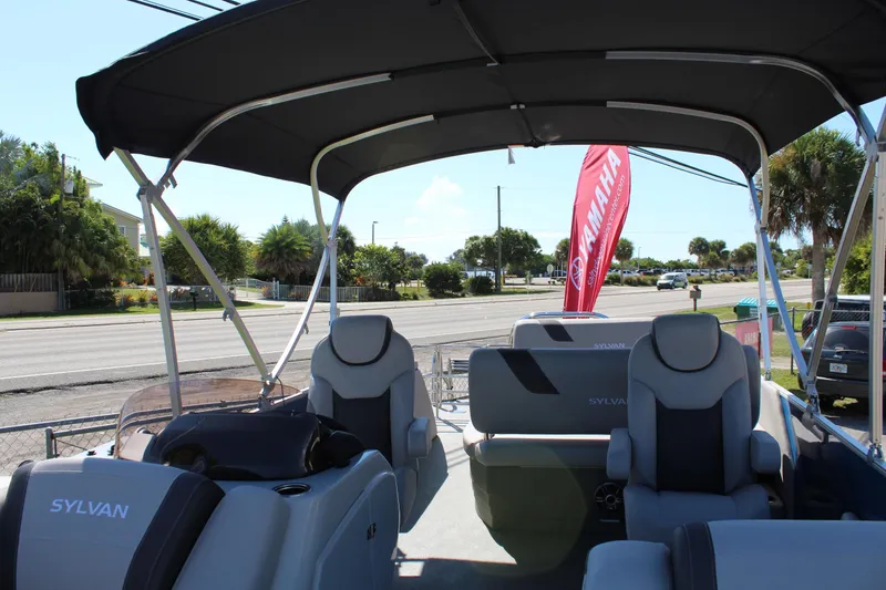 Slide: The Image of 2024 Sylvan L3 DLZ pontoon boat interior with seating and canopy. - 11