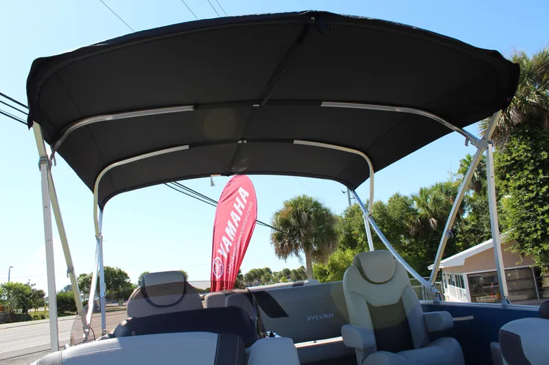 Slide: The Image of 2024 Sylvan L3 DLZ boat with canopy, outdoor display, Yamaha banner in background. - 5