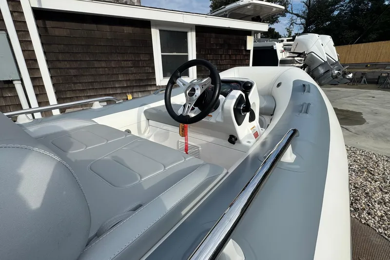 Slide: The Image of 2024 Williams Jet Tenders Sportjet 345 interior with steering wheel and seating. - 7