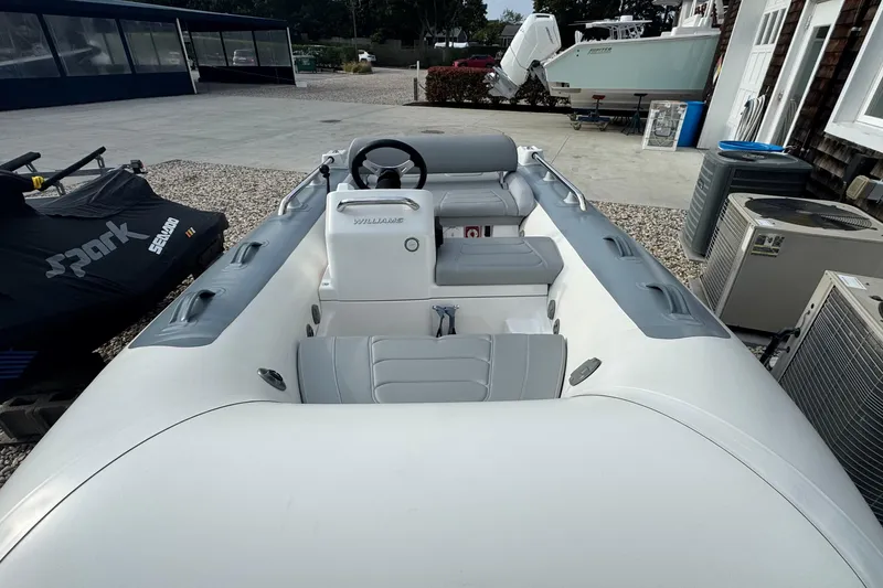 Slide: The Image of 2024 Williams Jet Tenders Sportjet 345, sleek design, gray seating, outdoor display. - 8