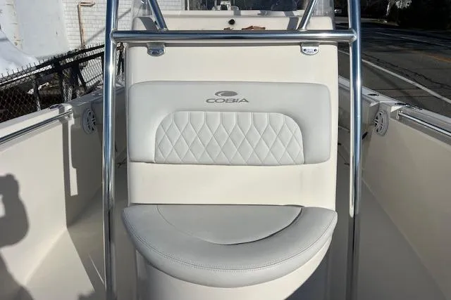 Slide: The Image of 2020 Cobia 237 Center Console boat interior with cushioned seating and stainless steel railing. - 13