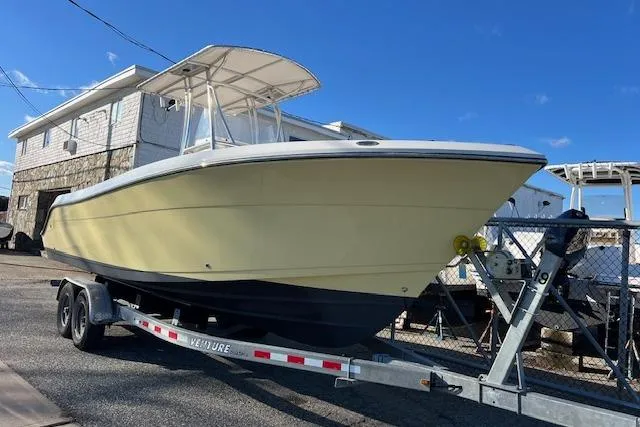 Slide: The Image of 2020 Cobia 237 Center Console boat on trailer, parked outdoors. - 4