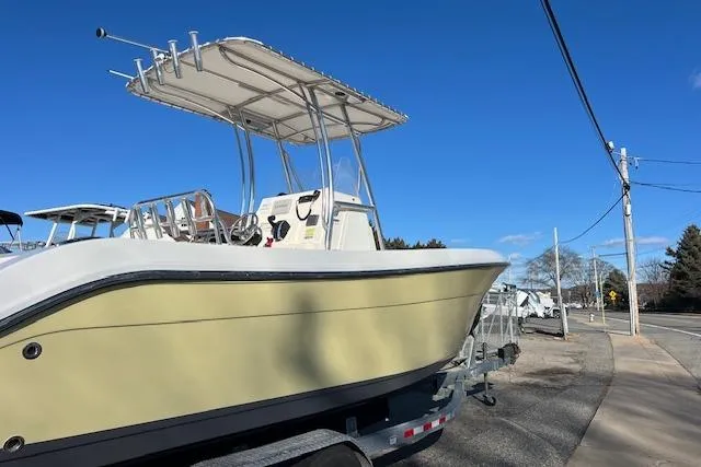 Slide: The Image of 2020 Cobia 237 Center Console boat on trailer under clear blue sky. - 6