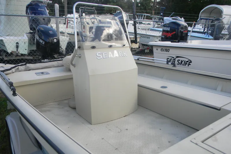 Slide: The Image of 2023 SeaArk 1660 c/c boat with center console, parked in a marina. - 7