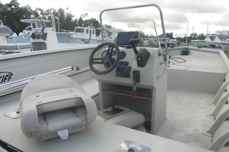 Slide: The Image of 2023 SeaArk 1660 c/c boat interior with steering console and seating. - 8
