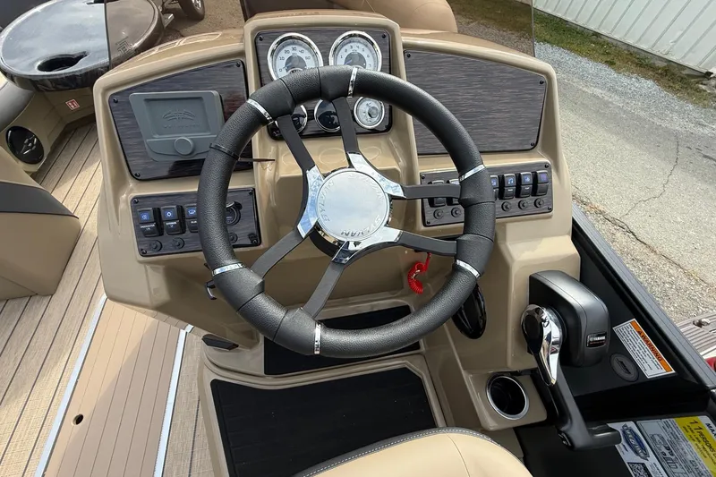Slide: The Image of 2026 Sylvan X-1 CLZ DH boat dashboard with steering wheel and control panel. - 10