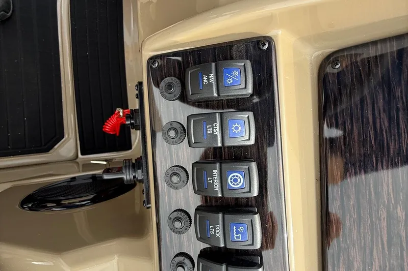 Slide: The Image of Control panel of 2026 Sylvan X-1 CLZ DH boat with labeled switches. - 14