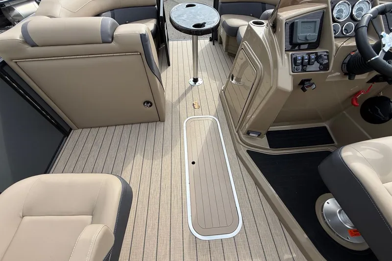 Slide: The Image of 2026 Sylvan X-1 CLZ DH boat interior with beige seating and modern dashboard. - 15