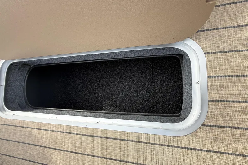 Slide: The Image of Open storage compartment in 2026 Sylvan X-1 CLZ DH boat. - 16