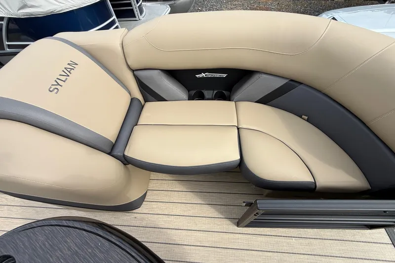 Slide: The Image of Luxurious seating on 2026 Sylvan X-1 CLZ DH boat, featuring beige and gray upholstery. - 24