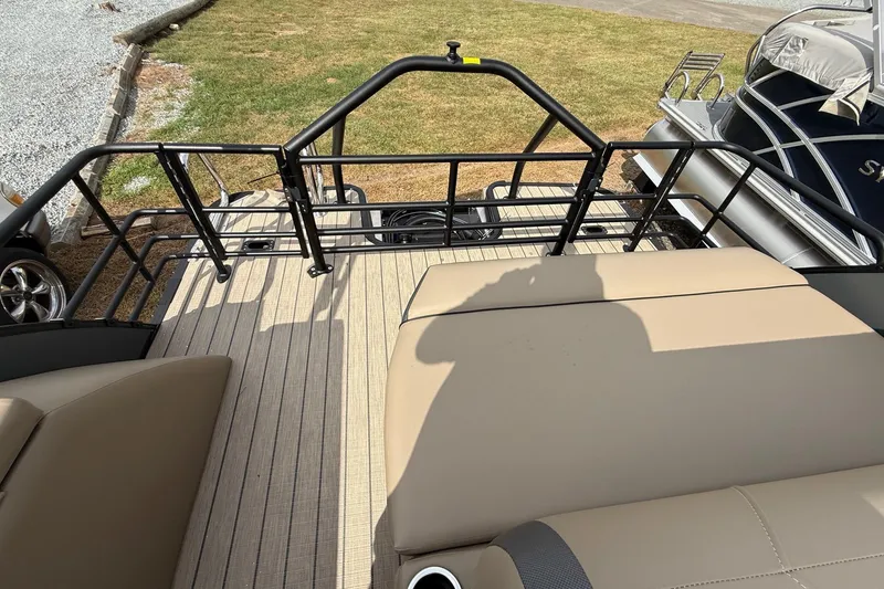 Slide: The Image of 2026 Sylvan X-1 CLZ DH boat interior with beige seating and railing. - 29