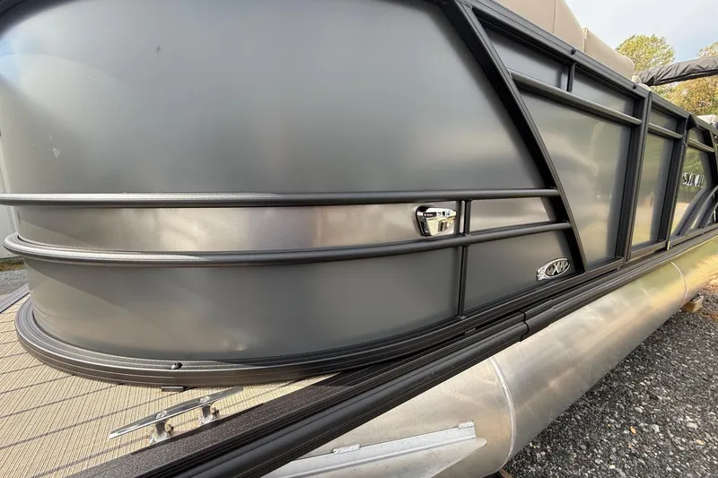 Slide: The Image of 2026 Sylvan X-1 CLZ DH pontoon boat, sleek metallic exterior design. - 5