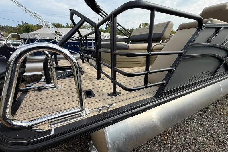 Slide: The Image of 2026 Sylvan X-1 CLZ DH pontoon boat with sleek railing and comfortable seating. - 6