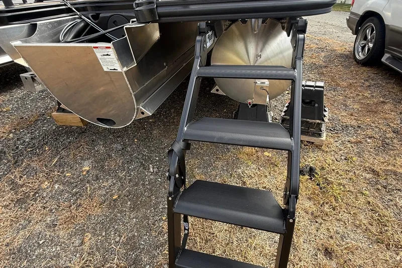 Slide: The Image of Rear view of 2026 Sylvan X-1 CLZ DH boat with foldable boarding ladder. - 7