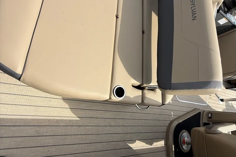 Slide: The Image of 2026 Sylvan X-1 CLZ DH boat interior with beige seating and cup holder. - 9