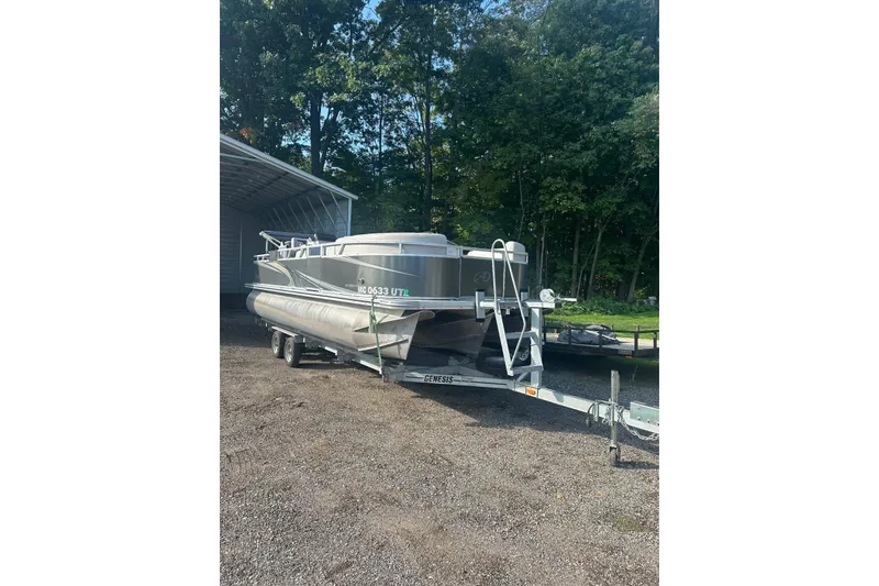 The Image of 2022 Avalon GS 2385 RF pontoon boat on trailer, parked outdoors near trees. - 0