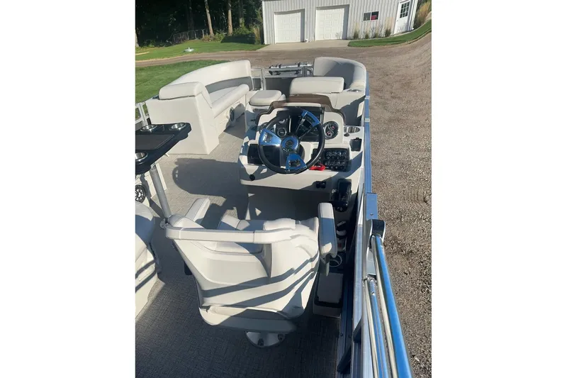 Slide: The Image of 2022 Avalon GS 2385 RF pontoon boat interior with steering console and seating. - 2