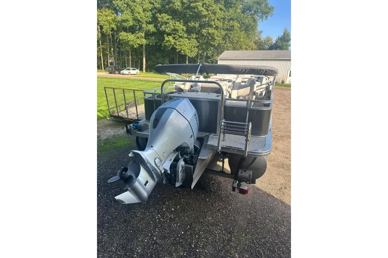 Slide: The Image of 2022 Avalon GS 2385 RF pontoon boat with outboard motor, parked outdoors. - 5