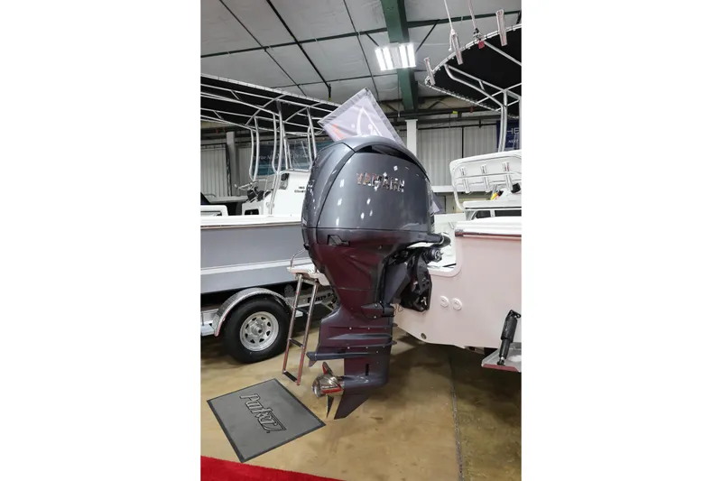 Slide: The Image of 2026 Parker 180 Coastal boat with powerful outboard motor in showroom display. - 9